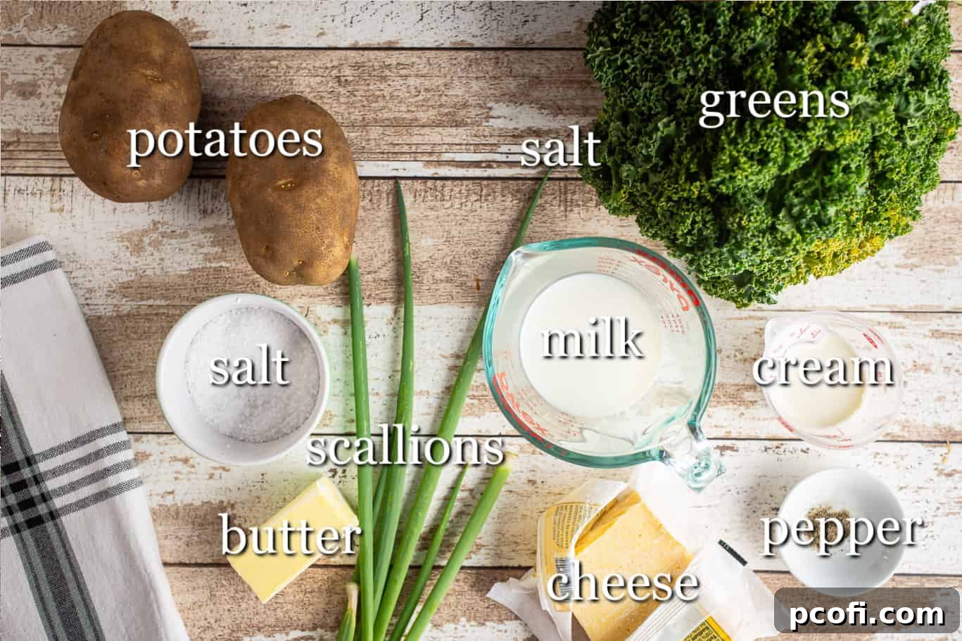 Various fresh ingredients for making cheesy colcannon, including russet potatoes, kale, scallions, butter, and Irish cheddar cheese.
