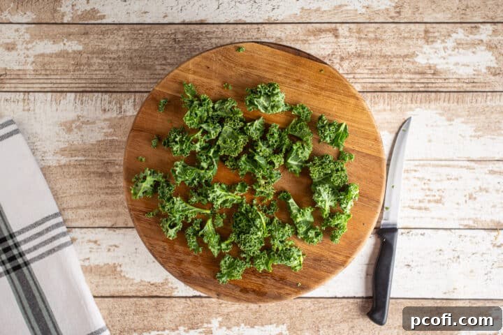 Roughly chopped kale leaves on a cutting board, ready to be added to the colcannon mixture.