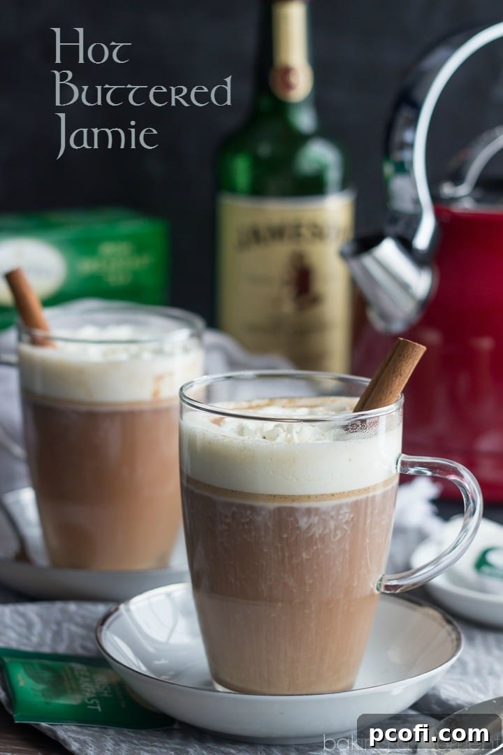 Close-up of a Hot Buttered Jamie, a rich and inviting hot toddy, with a swirl of whipped cream and a hint of cinnamon. The steam rising suggests its comforting warmth, ideal for cold afternoons.