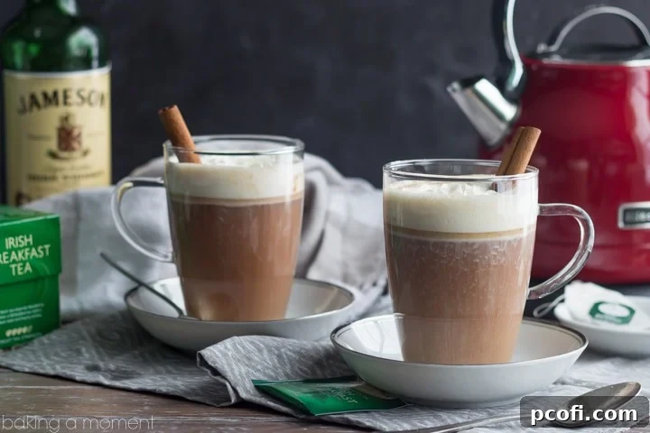 A cozy close-up of a Hot Buttered Jamie in a mug, showcasing the rich color of the tea and whiskey blend, ready to be enjoyed during a cold winter evening.
