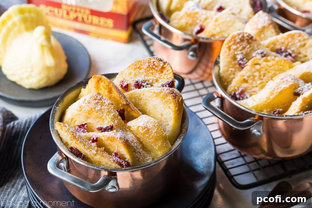 Individual bread & butter puddings in mini copper pots, dusted with powdered sugar & with a Thanksgiving turkey butter sculpture in the background. 