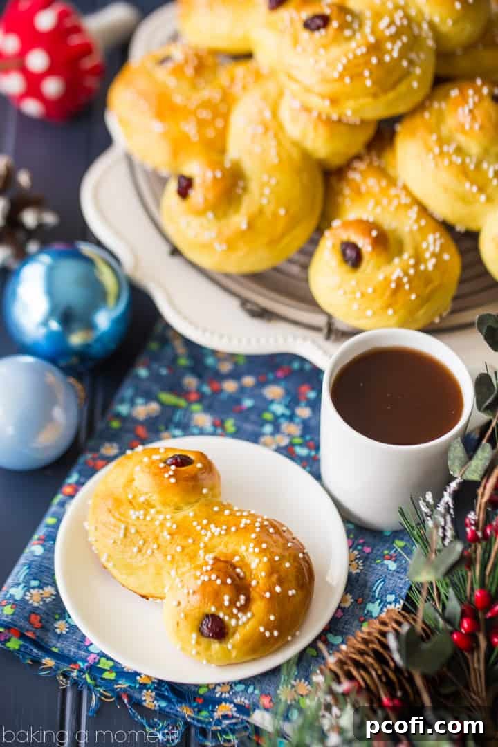 A trio of perfectly baked saffron-scented Lucia Buns, adorned with pearl sugar and dried cranberries, showcased against a soft, festive backdrop. These light, soft, and slightly sweet Swedish pastries embody a cherished centuries-old Scandinavian holiday tradition, ideal for pairing with coffee. Keywords: food, bread, desserts, baking, Swedish, luciabuns, stluciaday, holiday, saffron, pastries.