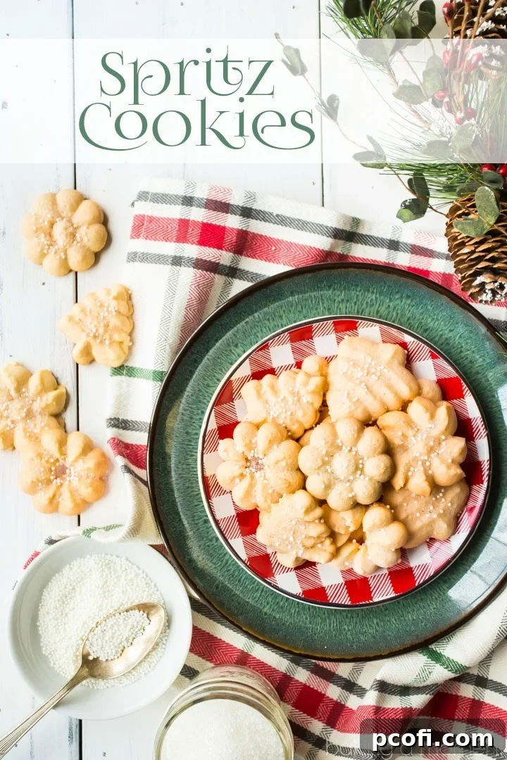 A close-up of a batch of perfectly baked spritz cookies, showcasing their light, crisp texture and golden edges, garnished with festive sprinkles. A true melt-in-your-mouth delight, ideal for holiday gatherings.