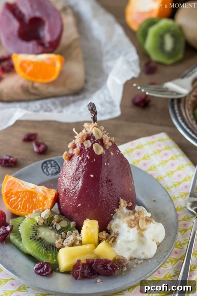 Serving of Sangria Poached Pears with crumble and whipped cream