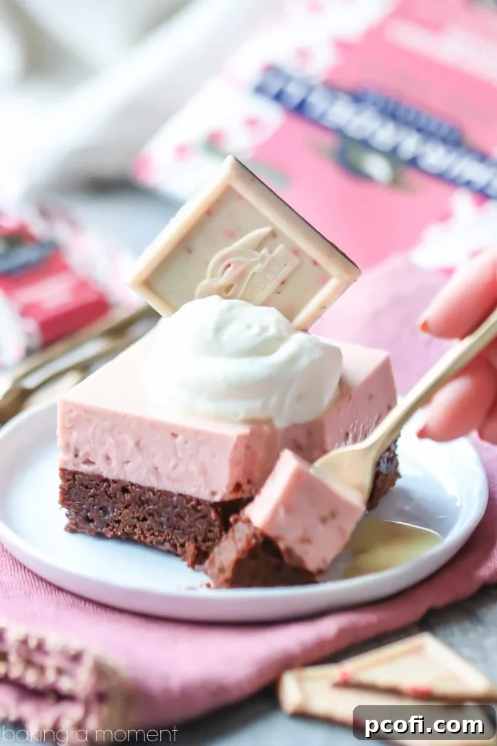 Chocolate Strawberry Mousse Bars: showcasing vibrant layers of a rich, nearly-flourless chocolate torte and airy, pink strawberry mousse, elegantly topped with a glistening white chocolate glaze. A light and exquisite dessert.