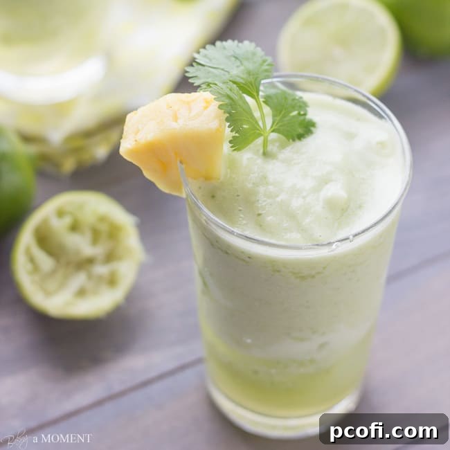 Frozen Pineapple Cilantro Mojito: A vibrant, icy blend of pineapple, cilantro, rum, and lime, perfect for summer. | Baking a Moment