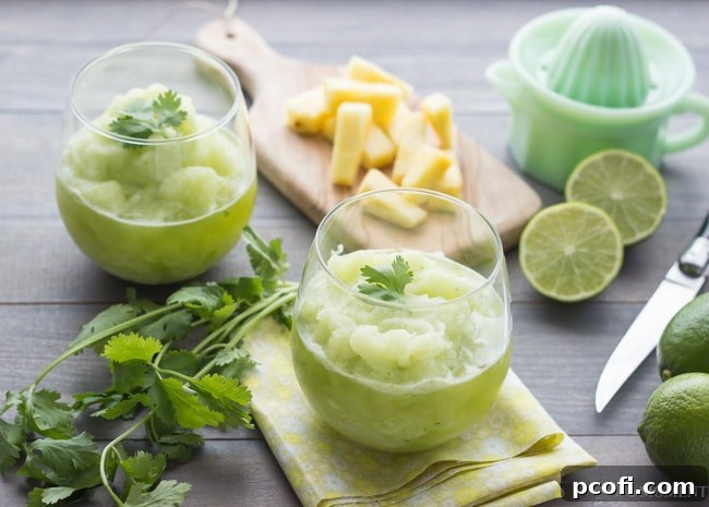 Ingredients for a Frozen Pineapple Cilantro Mojito laid out, including fresh pineapple chunks, lime, cilantro, rum, and sugar, on a light background. | Baking a Moment