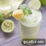 Frozen Pineapple Cilantro Mojito: A vibrant, icy blend of pineapple, cilantro, rum, and lime, perfect for summer. | Baking a Moment