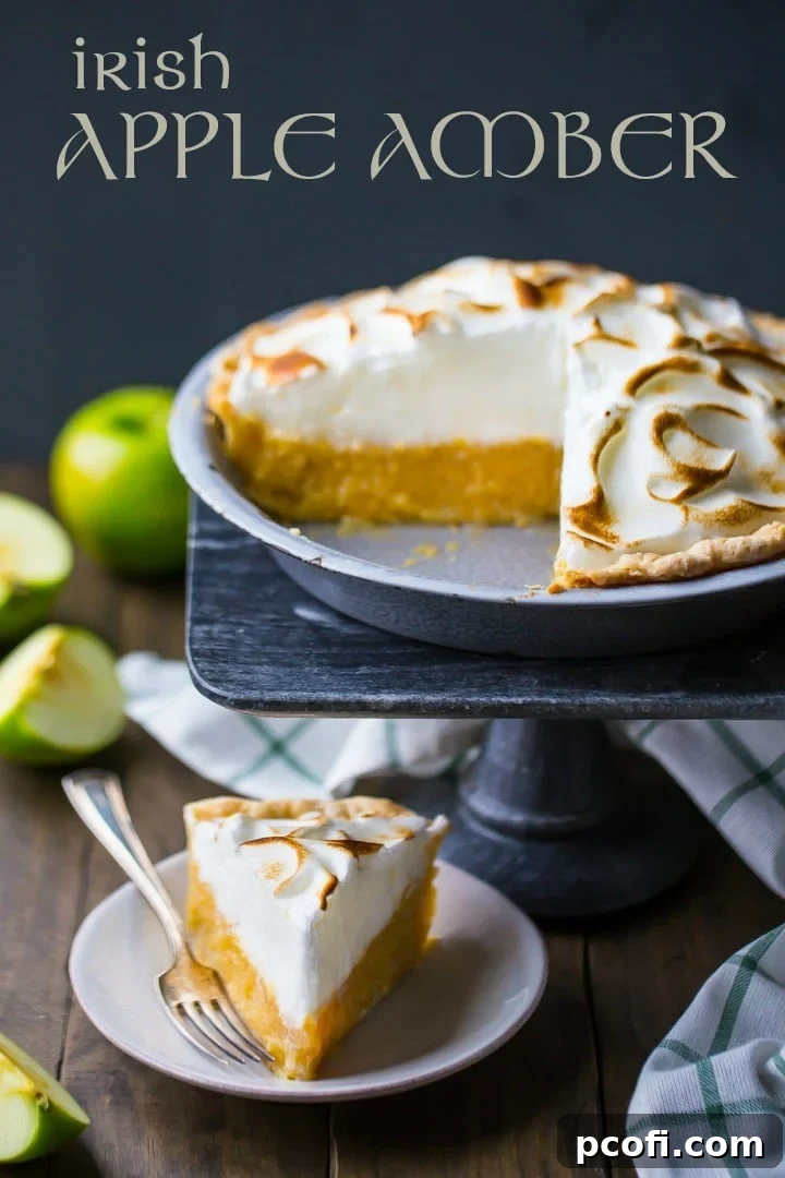 A whole Irish apple amber pie presented on a cake stand, with a single slice plated beautifully below it, ready to be enjoyed.