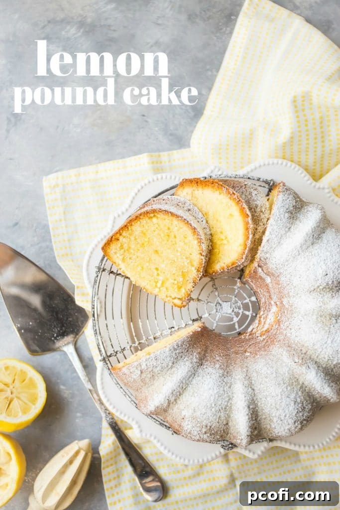 A beautifully sliced lemon pound bundt cake, lightly dusted with powdered sugar, resting on a wire cooling rack with a cheerful yellow napkin underneath. A cake server, fresh lemons, and a lemon juicer are thoughtfully arranged nearby, with a text overlay adding visual interest.