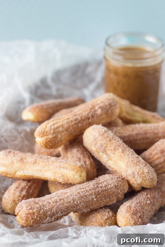 Baked Churros with Homemade Cajeta - A plate piled high with baked churros ready for dipping in cajeta.