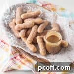 A small image of homemade cajeta and baked churros.