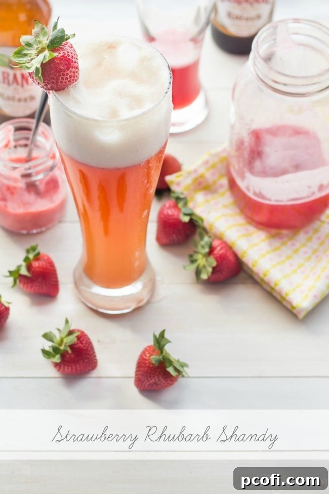 Close-up of a Strawberry Rhubarb Shandy, showcasing its beautiful rosy color and refreshing appeal.