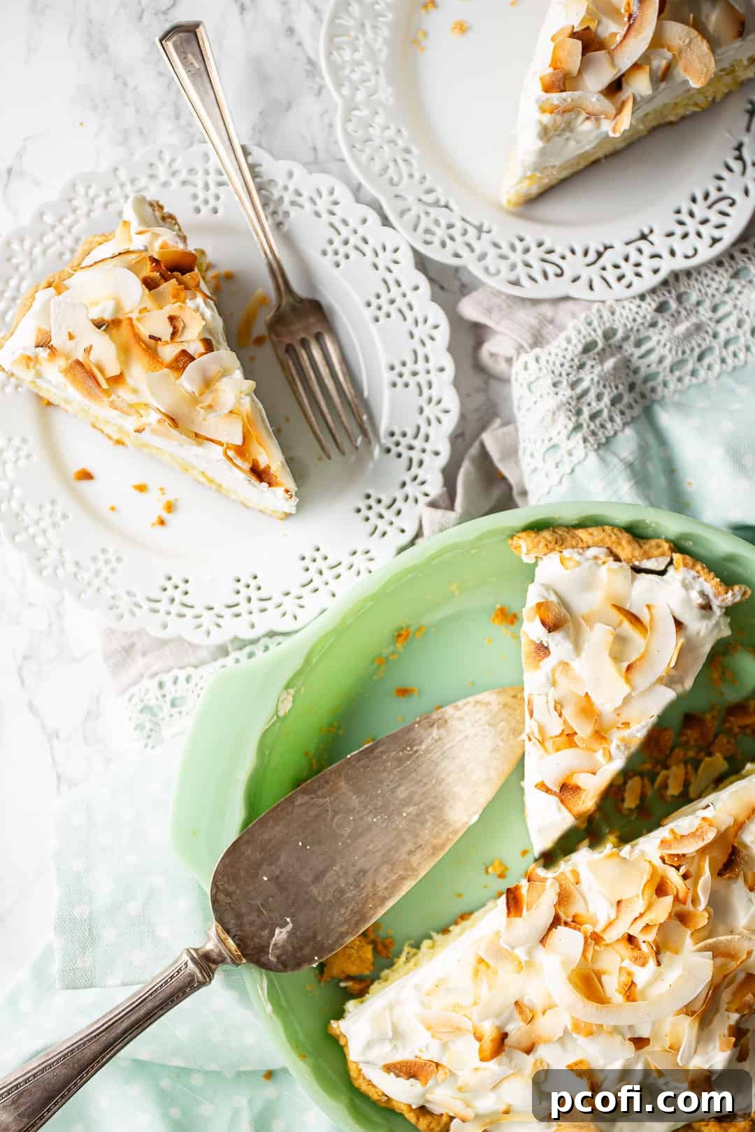 Coconut cream pie being served on white plates.