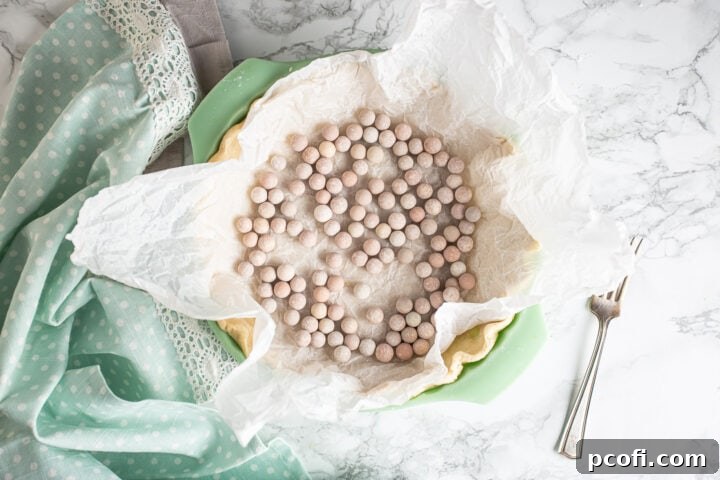Blind-baking a pie crust with ceramic pie weights.