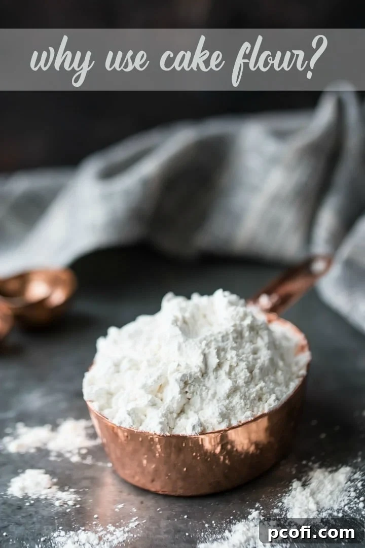 Vertical shot of a copper measuring cup filled with pristine white cake flour, highlighting its fine texture and light appearance, essential for delicate baked goods.