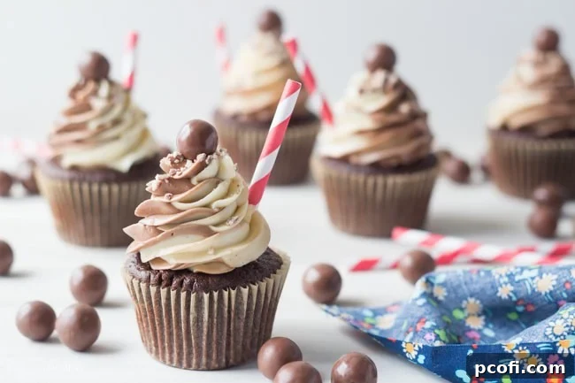 Two Black & White Malt Shoppe Cupcakes with malted milk ball garnish
