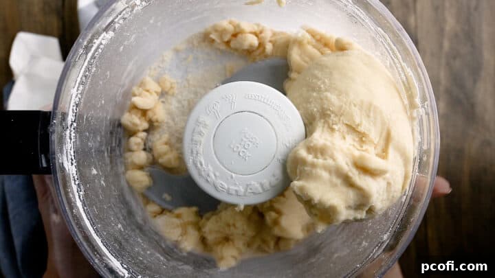 Scone dough in the bowl of a food processor.