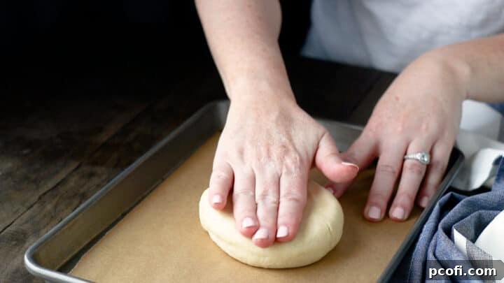 Flattening scone dough into a disc shape.