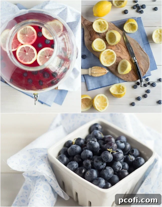 Pitcher of Blueberry Lavender Lemonade being poured into a glass, with ice, blueberries, and lemon slices.