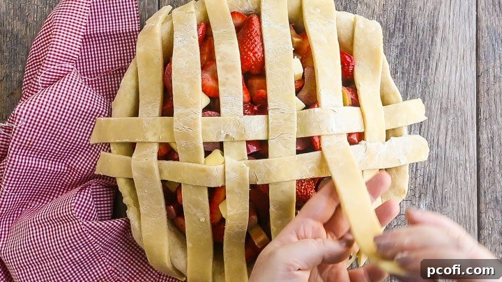 How to Make Lattice Pie Crust Step-by-Step: Weaving second horizontal strip.