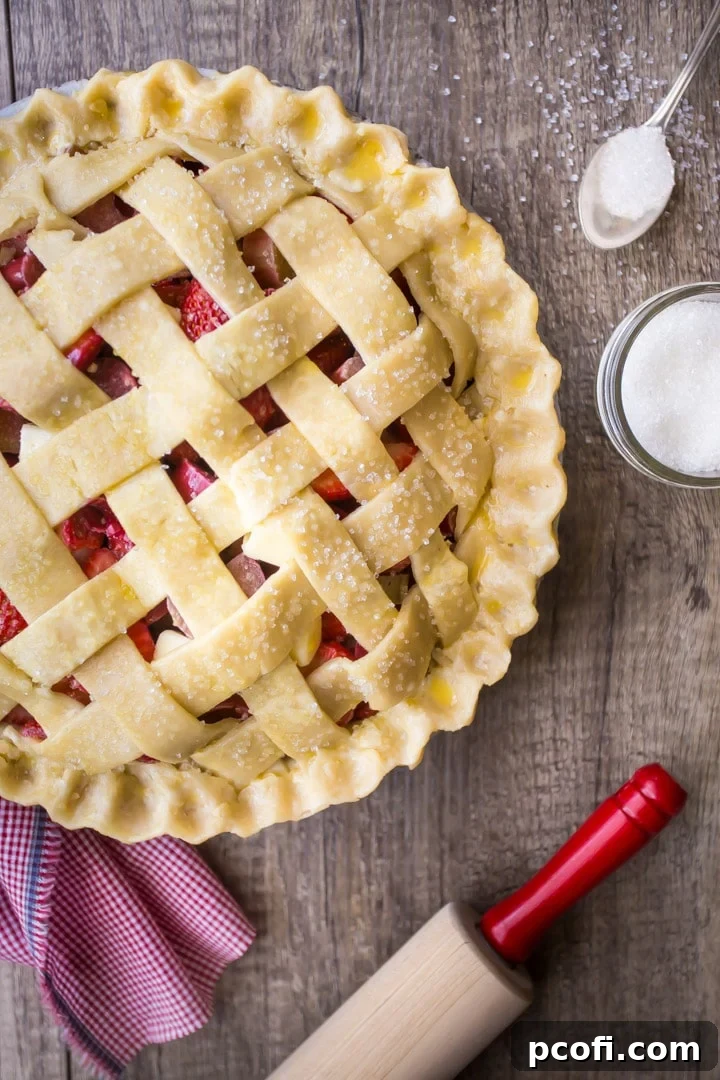 Sprinkling a lattice-top pie with sparkling sugar.