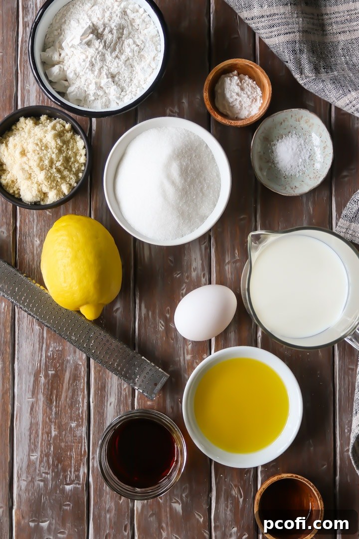 Various essential ingredients neatly arranged on a baking surface, prepared for making the olive oil cake.