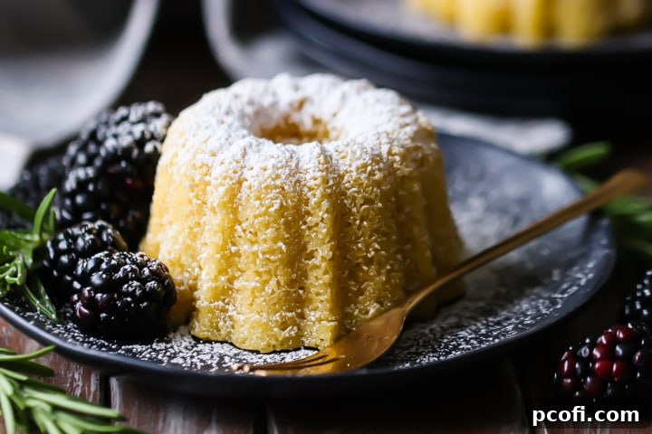 Close-up shot of a moist olive oil cake, highlighting its tender crumb and golden crust.