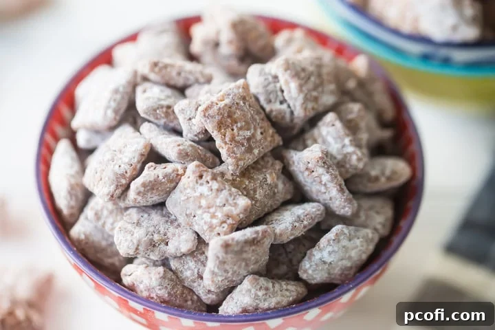 Large batch of homemade Muddy Buddies, also known as Puppy Chow, a chocolate peanut butter Chex mix covered in powdered sugar.