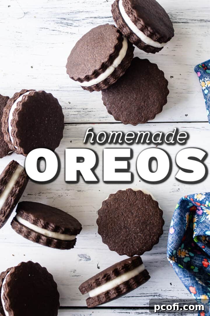 Homemade Oreo cookies, scattered over a distressed white tabletop, highlighting their delicious texture.