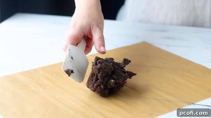 A perfectly formed homemade Oreo cookie dough ball, ready for rolling.