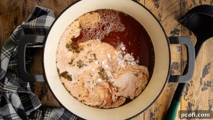 Adding cream to homemade tomato soup.
