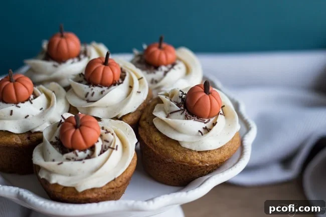 A beautifully arranged tray of freshly baked Pumpkin Chai Cupcakes, ready to be served and enjoyed.