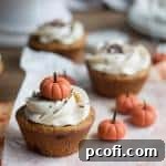 Pumpkin Chai Holiday Cupcakes with frosting and fondant pumpkin garnish