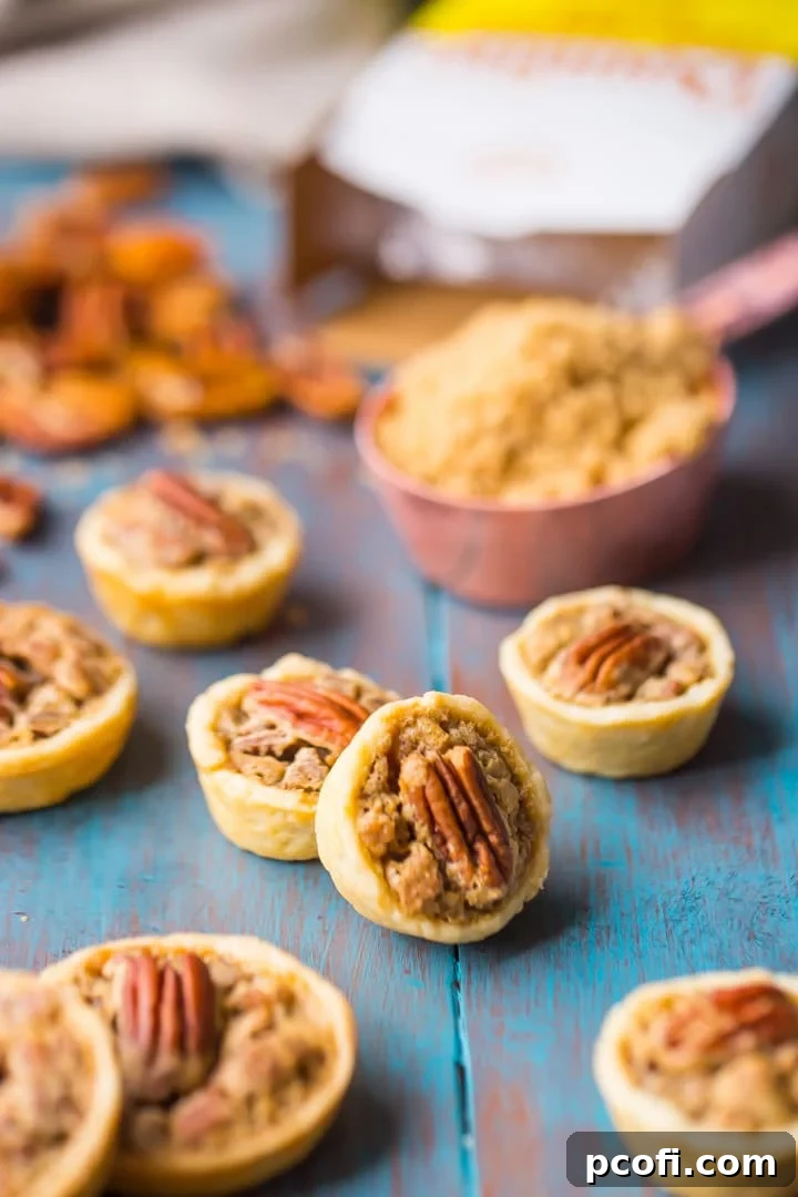 A batch of freshly baked Brown Sugar Pecan Tassies cooling on a rack, showcasing their golden crust and rich filling.