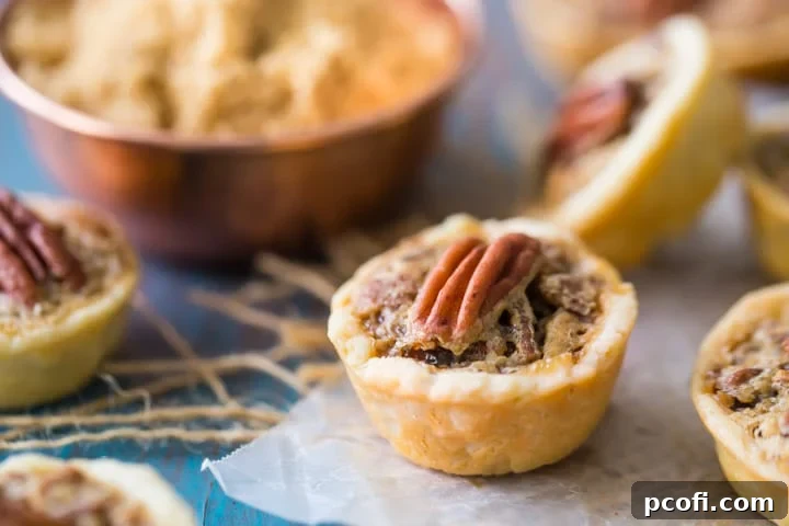A stack of traditional Pecan Tassies with golden crusts, ready for serving during the fall and holiday season.