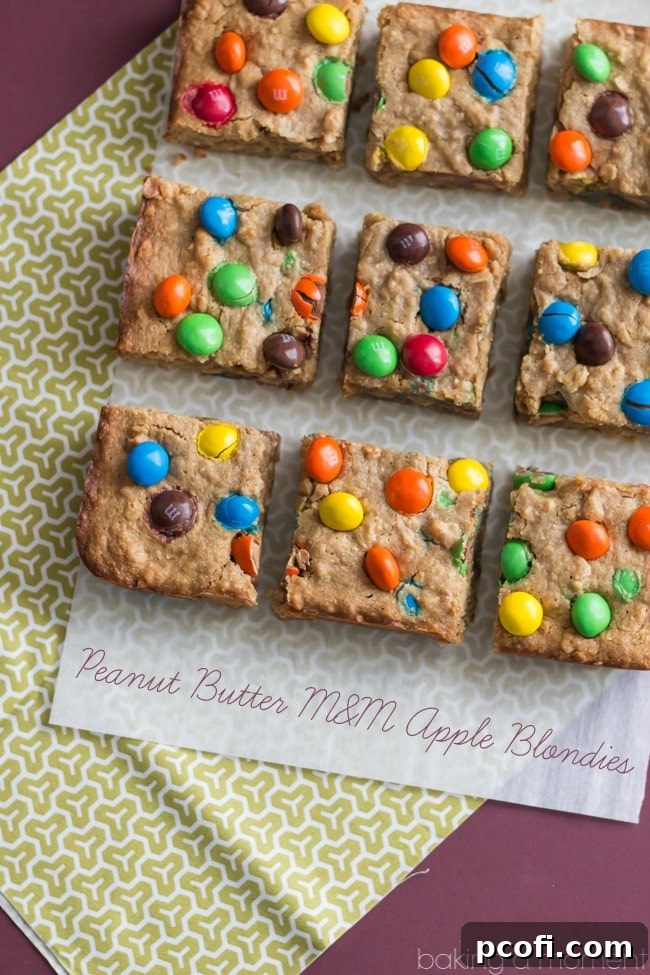 Close-up of Peanut Butter Apple Blondie Bars, showing the M&M's and texture.