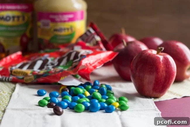 A batch of freshly baked Peanut Butter Apple Blondie Bars, infused with applesauce, oats, and M&M's.