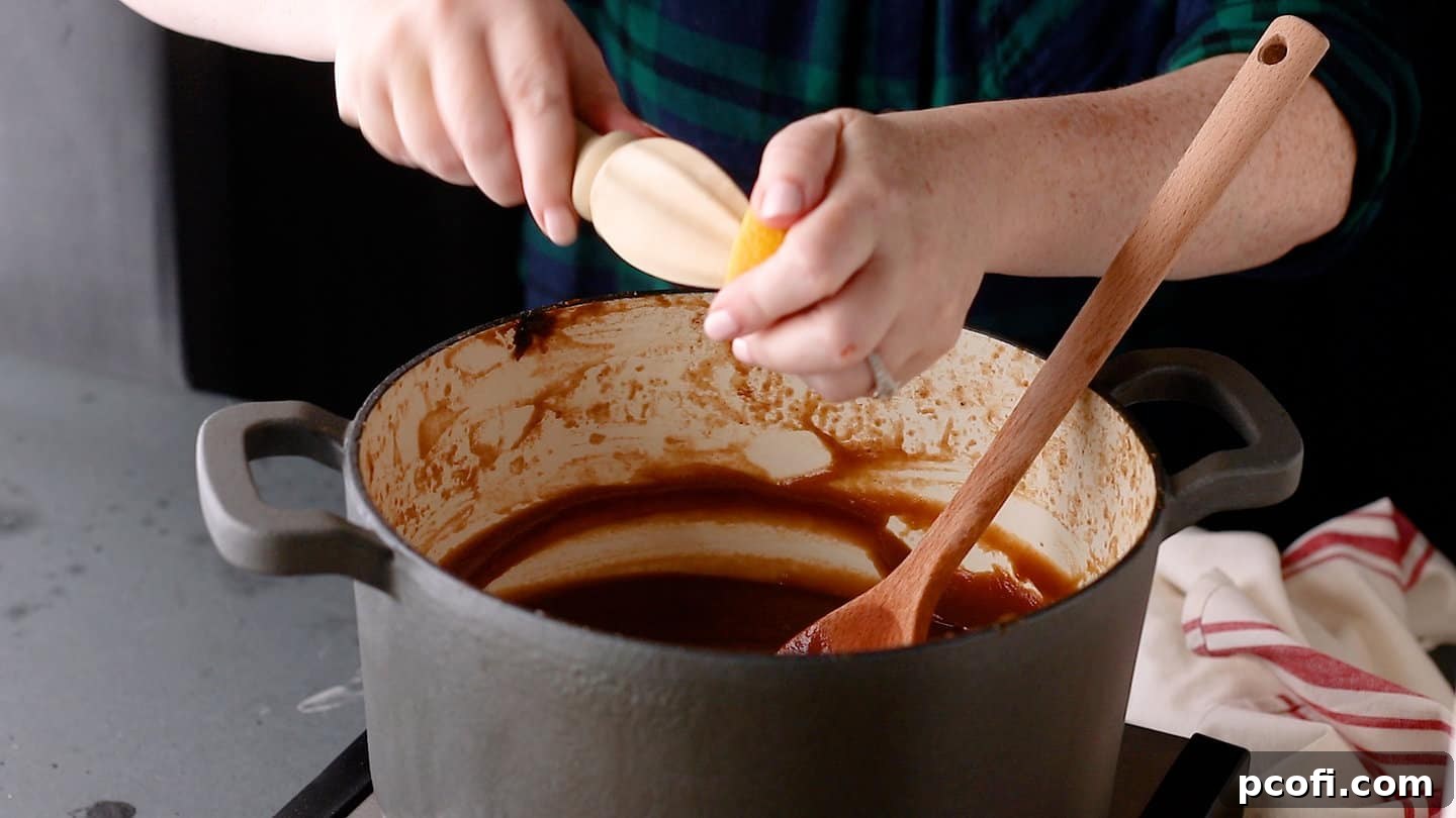 Squeezing fresh lemon juice into homemade apple butter.