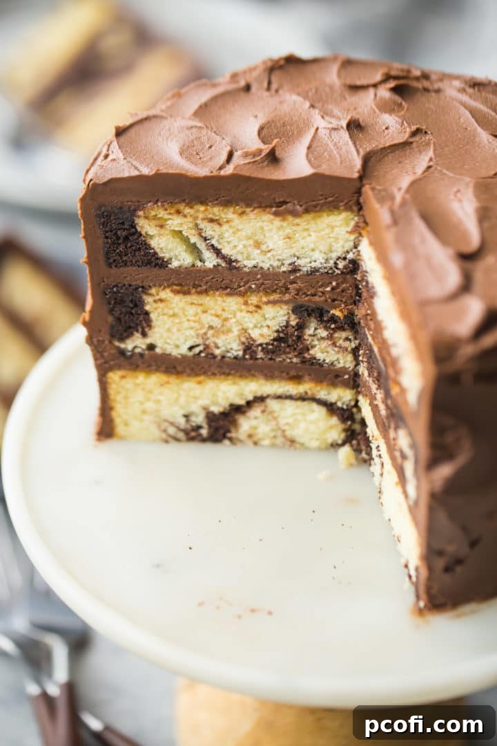 Close-up view of the inside of a beautifully baked homemade marble cake, showing its moist texture and distinct chocolate and vanilla swirls.
