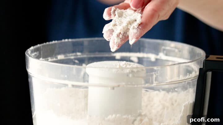 Butter cut into dry ingredients resembling coarse meal for tart pastry.