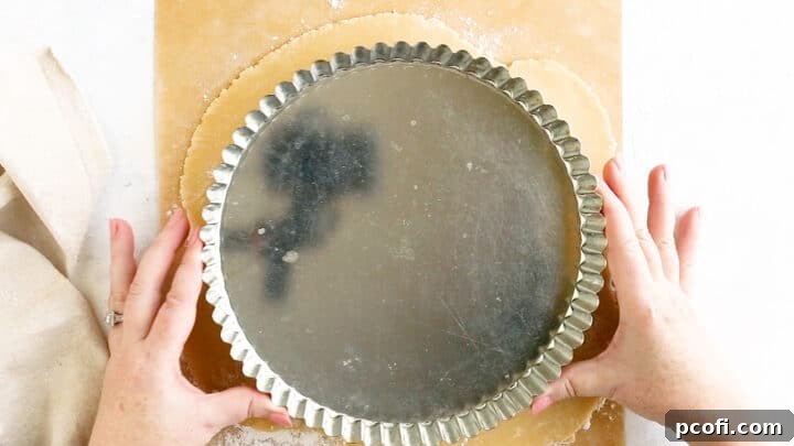 Rolling tart crust out to an inch or so wider than the pan for a perfect fit.