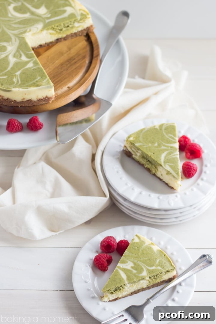 A close-up of a whole matcha swirl cheesecake, showcasing the perfectly baked and cooled dessert with its intricate green marbling and inviting golden-brown crust.
