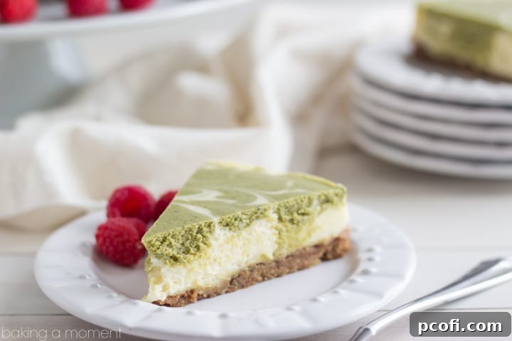 A vibrant green matcha swirl cheesecake, freshly sliced and ready to be served, highlighting its rich, creamy texture and inviting appearance.