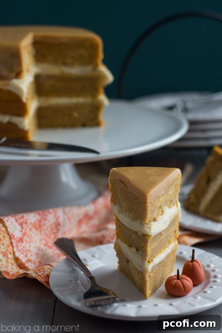 A beautifully presented slice of Pumpkin Boston Cream Pie on a white plate, showcasing its distinct layers of spiced cake, creamy maple custard, and the glossy caramelized white chocolate topping.