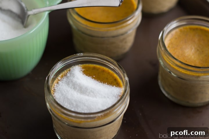 A selection of fresh ingredients for pumpkin creme brulee, including eggs, heavy cream, pumpkin puree, and spices.