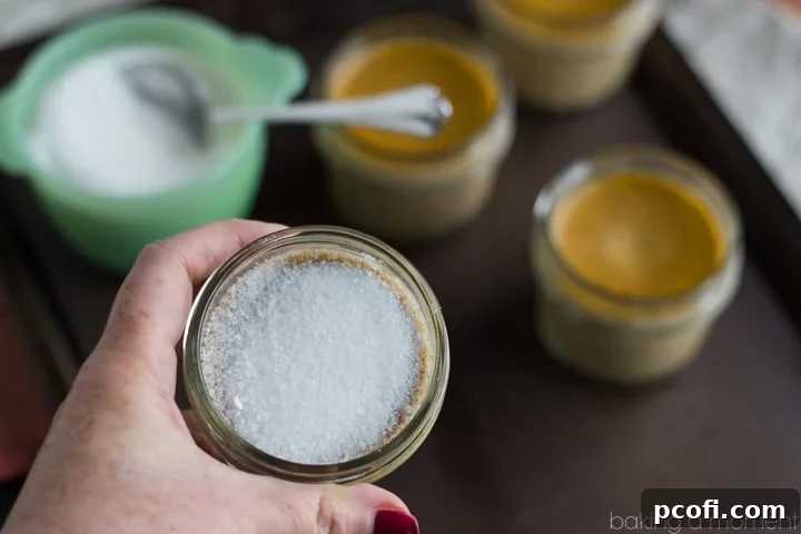 Preparing the pumpkin custard mixture in a glass bowl with a whisk, showing a smooth consistency.