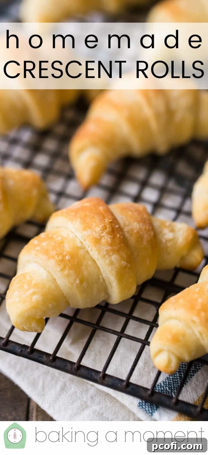 Close-up image of homemade crescent rolls on a wire cooling rack, with a text overlay reading "Homemade Crescent Rolls."