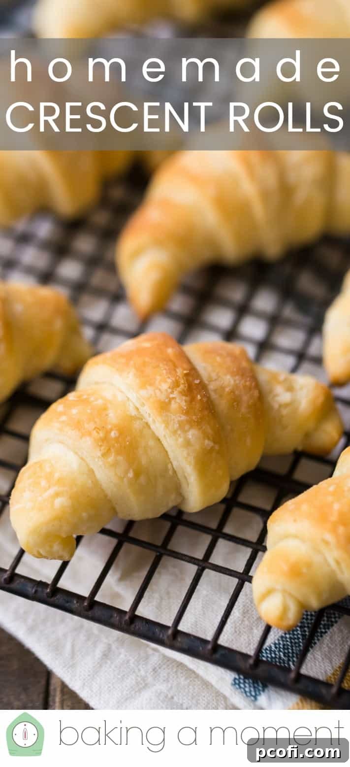 Close-up image of homemade crescent rolls on a wire cooling rack, with a text overlay reading "Homemade Crescent Rolls."