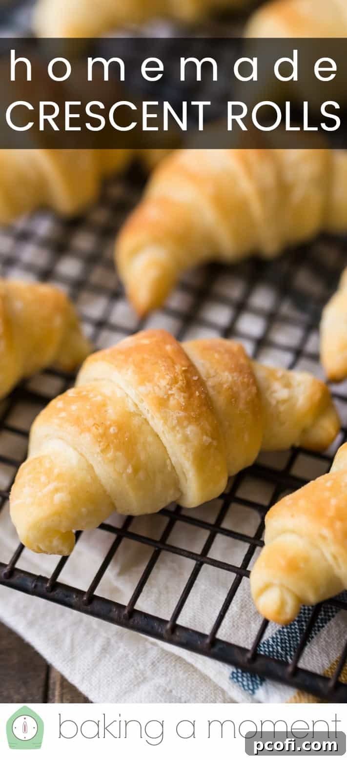 Close-up image of homemade crescent rolls on a wire cooling rack, with a text overlay reading "Homemade Crescent Rolls."